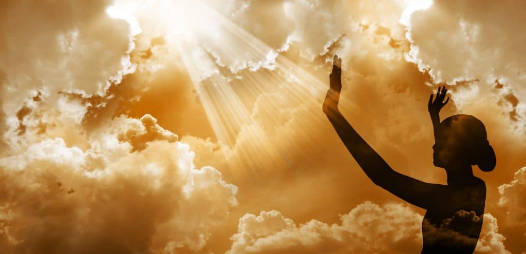 Hands reaching out to sunlit sky for worship - Paul Wagner