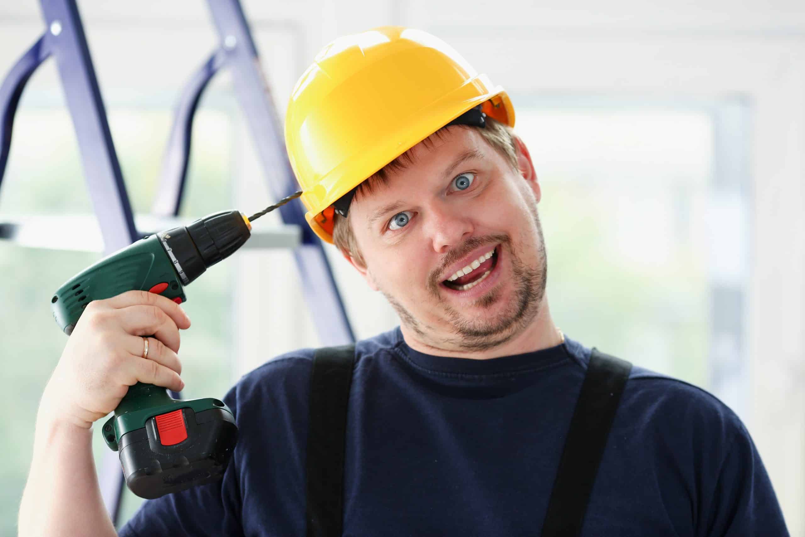 Idiot, a man putting drill to hardhat on head - Paul Wagner
