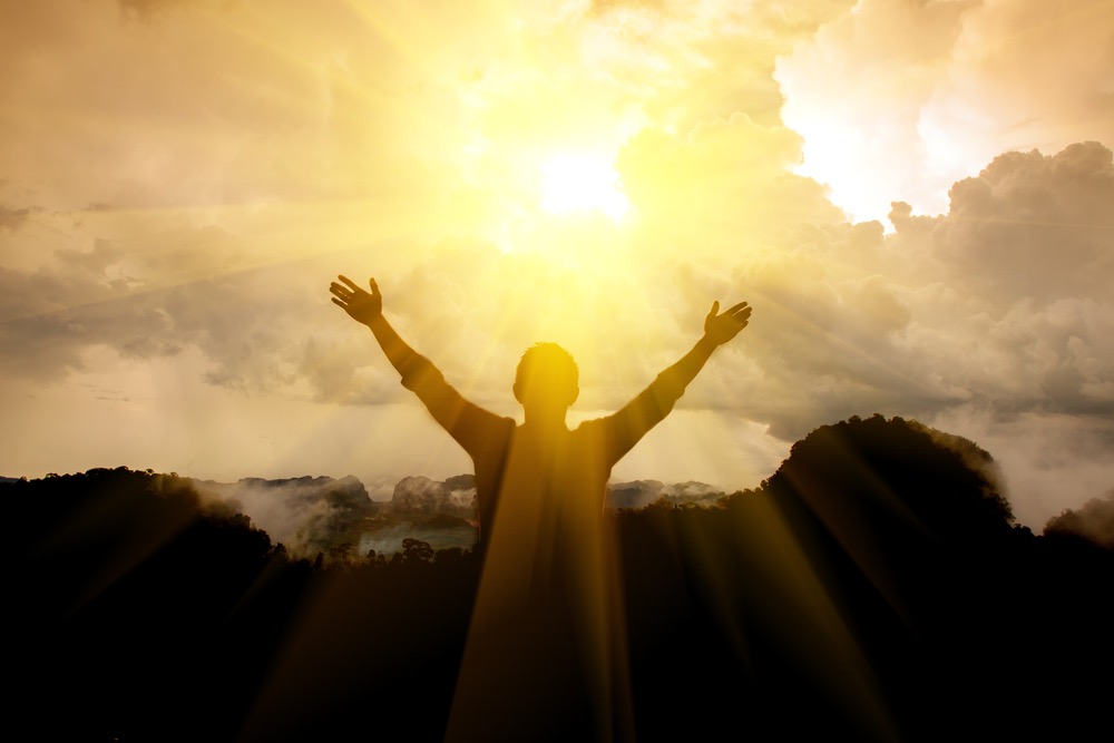 Image showing man with hands wide open in prayer toward the sunny skies