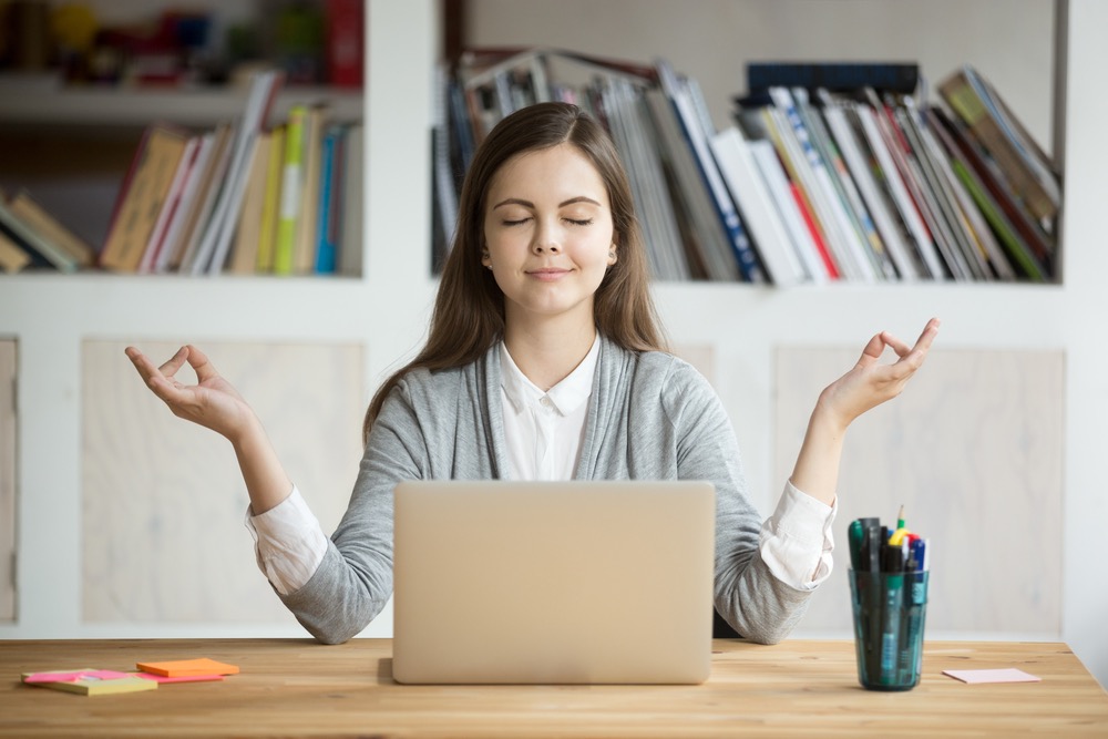 Spiritual entrepreneur meditating at work — symbol of redefining success from profit to dharma