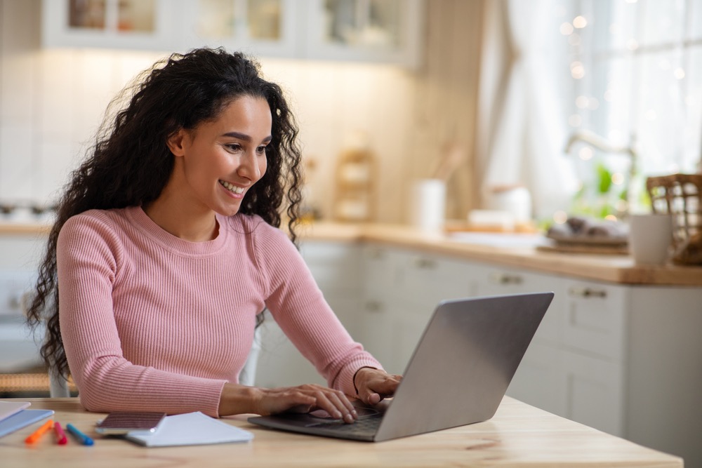 Woman shown enjoying work, representing empowerment and joy on the path of dharma through business